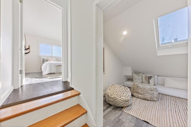 interior space with a skylight and hardwood / wood-style flooring