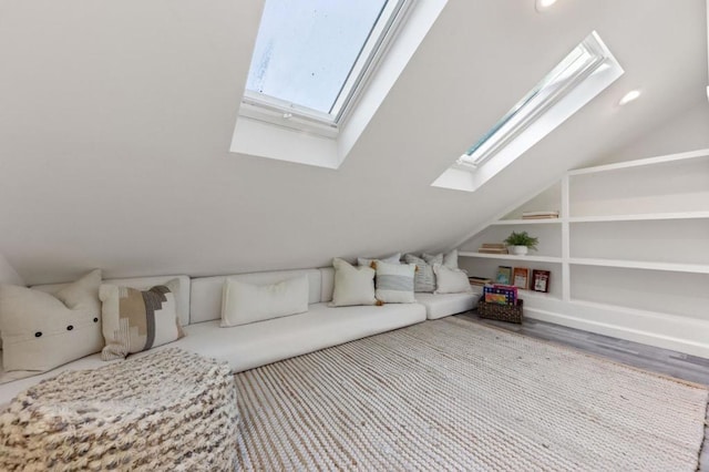 interior space featuring built in shelves and vaulted ceiling