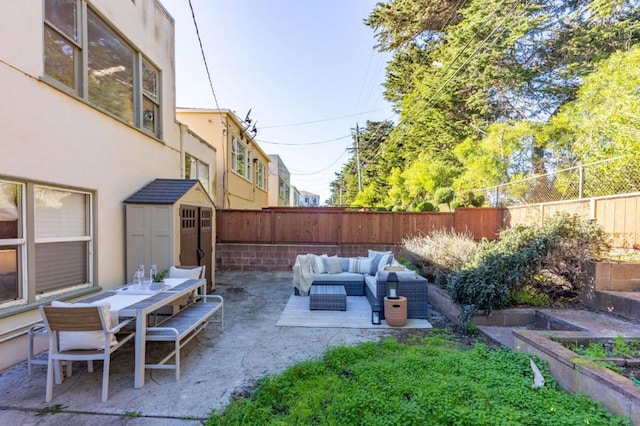 view of patio with a storage shed and an outdoor living space