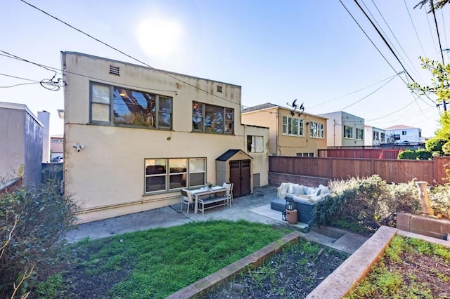 rear view of property with a patio area, outdoor lounge area, and a yard