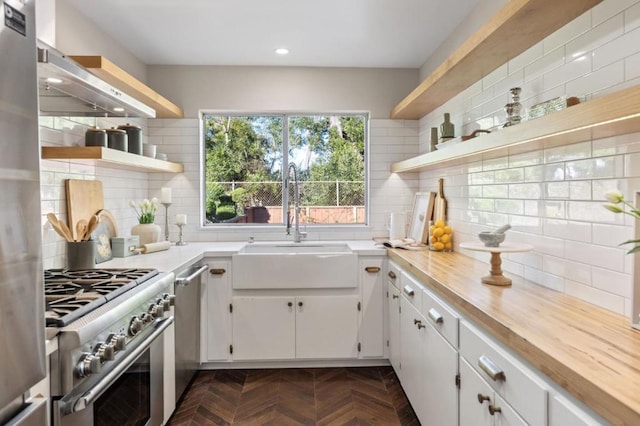 kitchen featuring stainless steel appliances, backsplash, and white cabinets