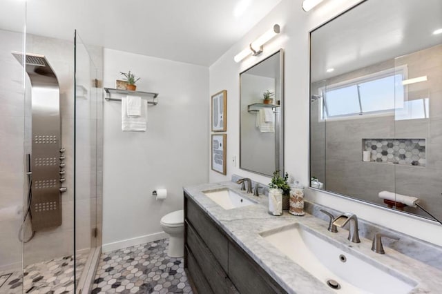 bathroom featuring tile patterned floors, tiled shower, vanity, and toilet