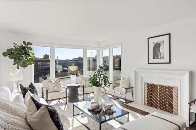 living room featuring a brick fireplace and hardwood / wood-style floors