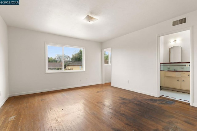 unfurnished room with dark wood-type flooring