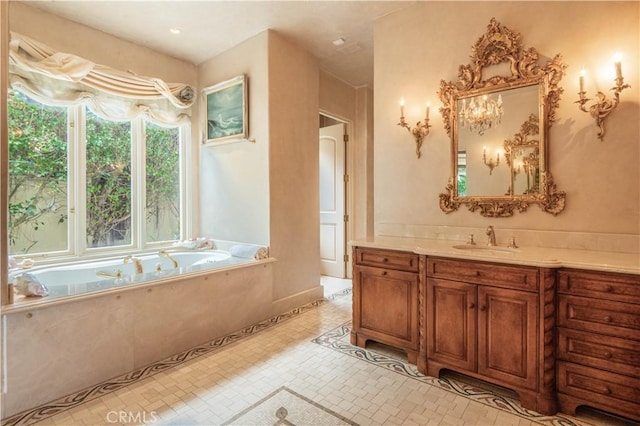 bathroom featuring tiled tub, vanity, and tile patterned flooring