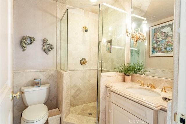 bathroom featuring vanity, toilet, an enclosed shower, and tile walls