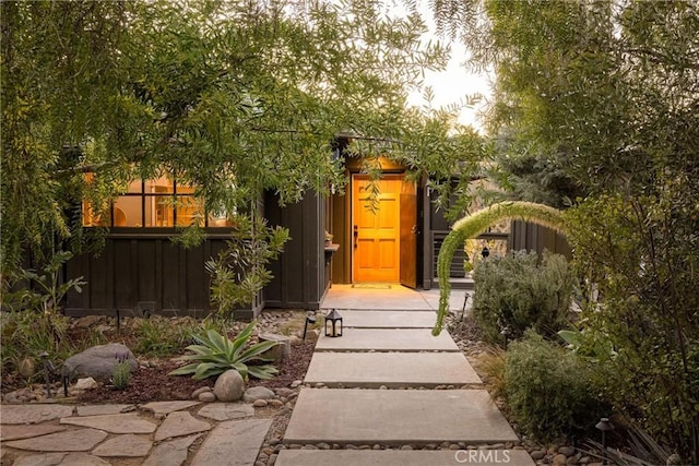 doorway to property featuring board and batten siding