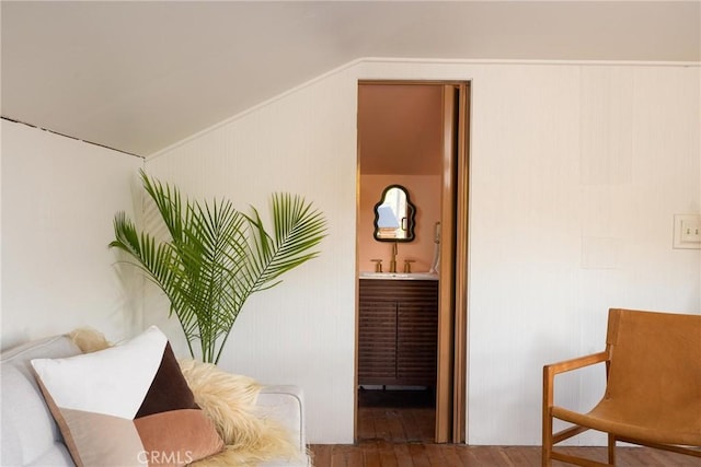 sitting room with vaulted ceiling and wood finished floors