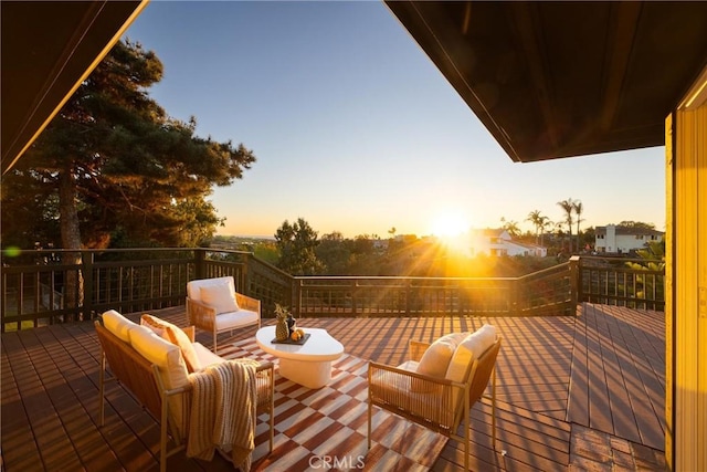 deck at dusk featuring outdoor lounge area