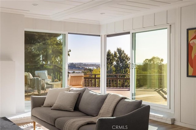 sunroom / solarium featuring beam ceiling