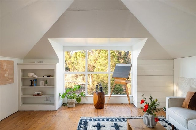 additional living space with lofted ceiling and wood finished floors