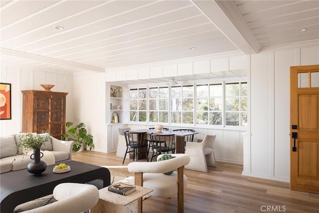 sunroom / solarium featuring beam ceiling