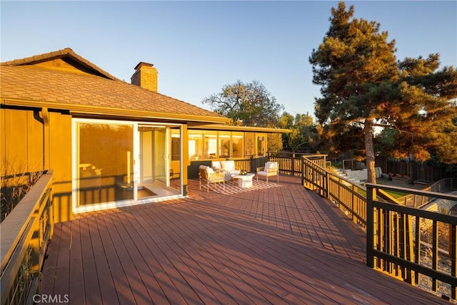 wooden terrace with an outdoor hangout area