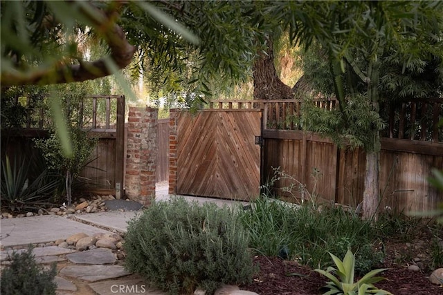 view of gate with fence