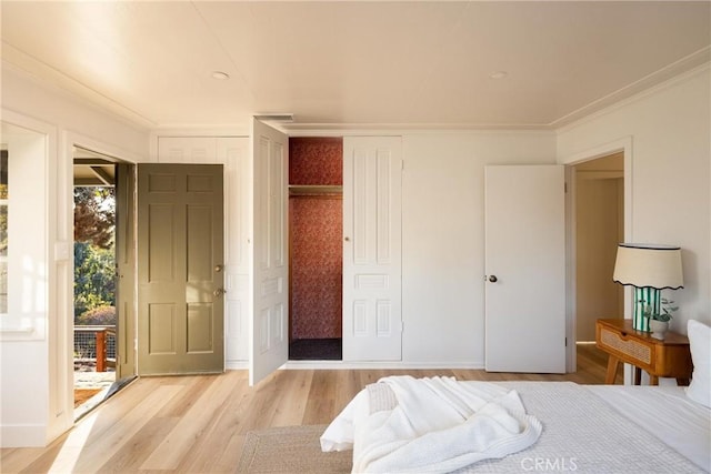 bedroom featuring light wood-type flooring, baseboards, and ornamental molding