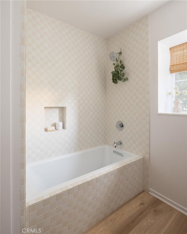 bathroom featuring shower / bathtub combination and wood finished floors