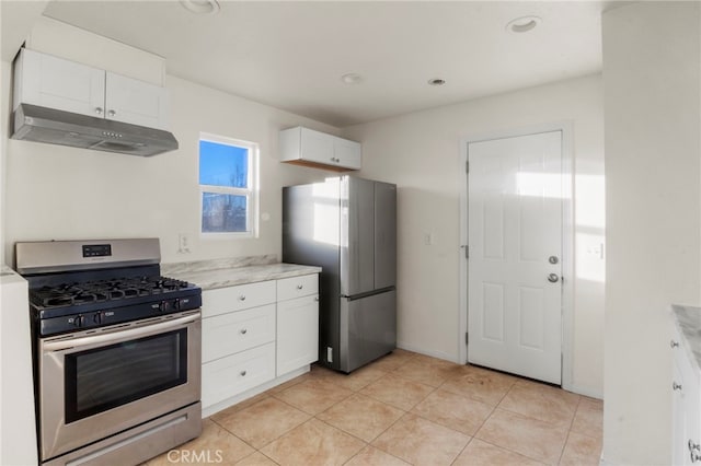 kitchen featuring white cabinets, light tile patterned flooring, and stainless steel appliances