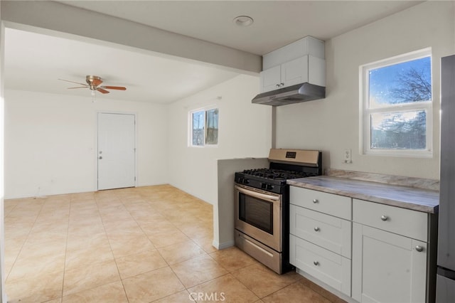 kitchen with ceiling fan, light tile patterned floors, white cabinets, and stainless steel gas range oven