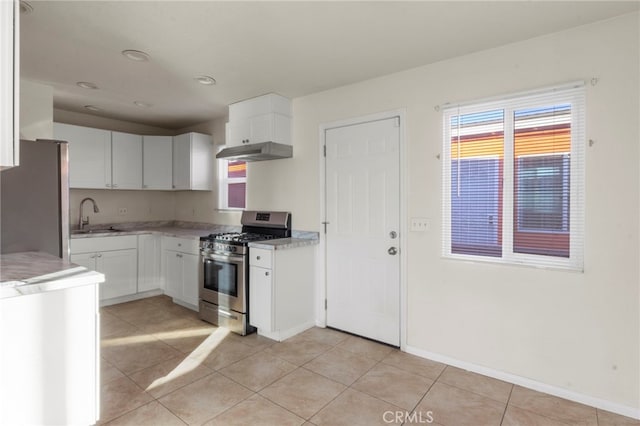 kitchen featuring light tile patterned floors, sink, white cabinetry, and appliances with stainless steel finishes