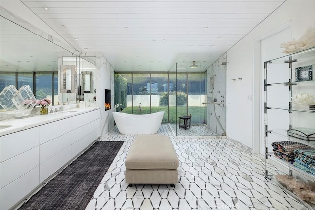 2538 Monaco Dr, Laguna Beach, CA 92651 - bathroom featuring a shower stall, a soaking tub, double vanity, plenty of natural light, and floor to ceiling windows