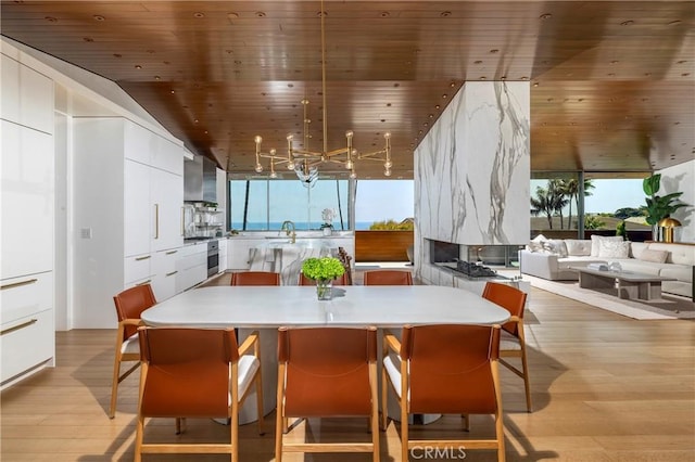 2538 Monaco Dr, Laguna Beach, CA 92651 - dining space featuring wood ceiling, light wood finished floors, plenty of natural light, and a chandelier