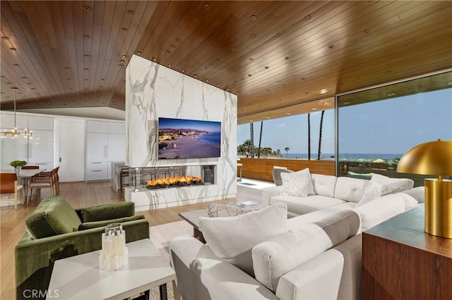 2538 Monaco Dr, Laguna Beach, CA 92651 - living area with wooden ceiling, wood finished floors, vaulted ceiling, a high end fireplace, and a chandelier