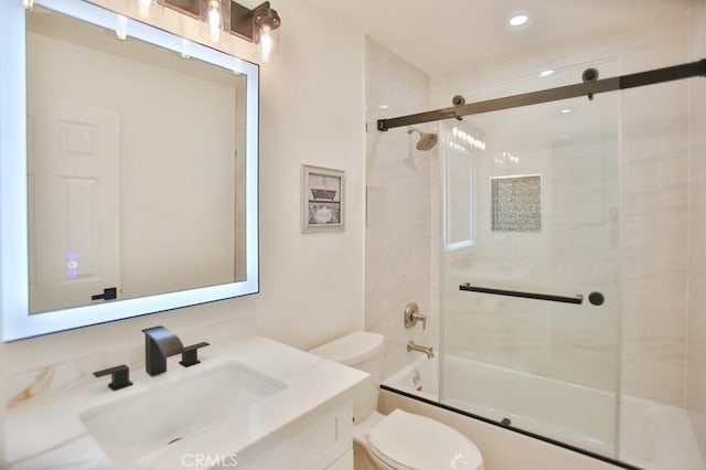 full bathroom with toilet, bath / shower combo with glass door, and vanity