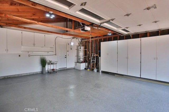 garage with water heater and a garage door opener