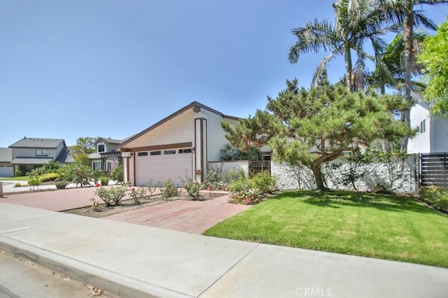 view of front of home with a front yard and a garage