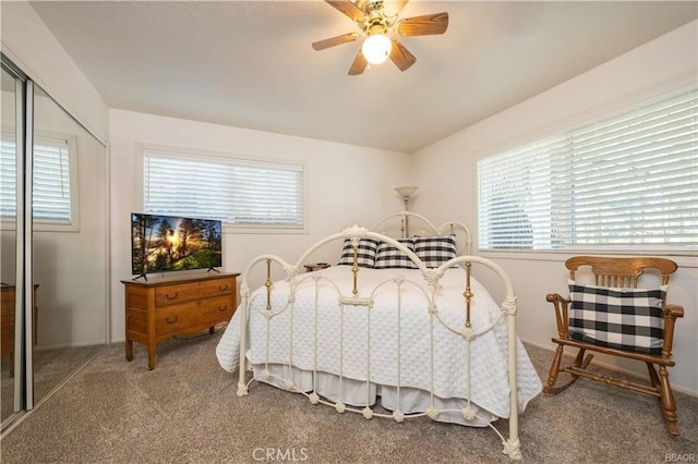 bedroom featuring ceiling fan, a closet, carpet floors, and multiple windows