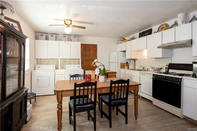 kitchen featuring washer / dryer, white cabinets, and white appliances