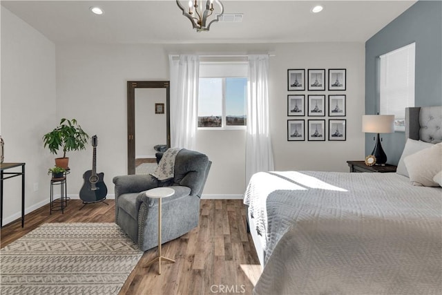 bedroom with recessed lighting, visible vents, baseboards, and wood finished floors