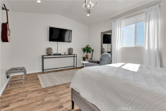 bedroom with baseboards, lofted ceiling, light wood-type flooring, a chandelier, and recessed lighting