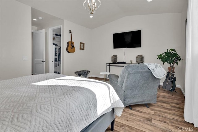 bedroom with a notable chandelier, recessed lighting, vaulted ceiling, wood finished floors, and baseboards