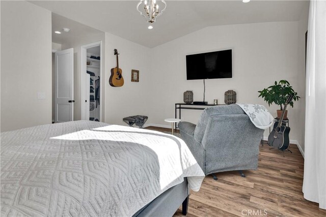 bedroom featuring recessed lighting, baseboards, wood finished floors, and lofted ceiling