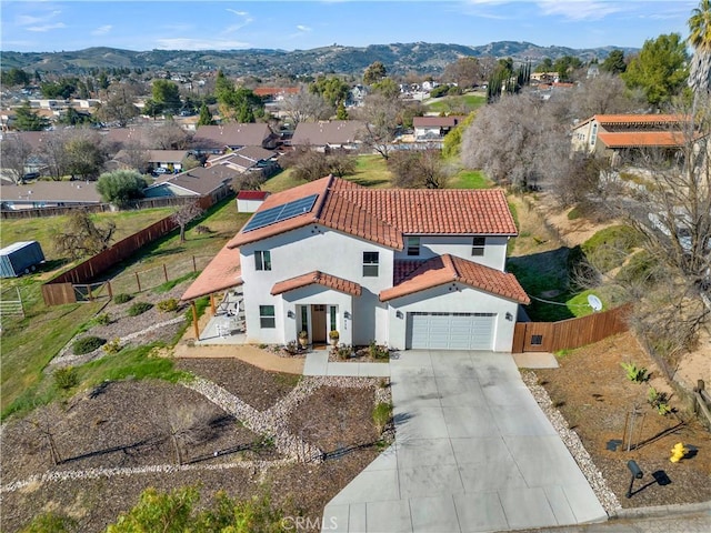 exterior space featuring a tiled roof, fence, a mountain view, and stucco siding