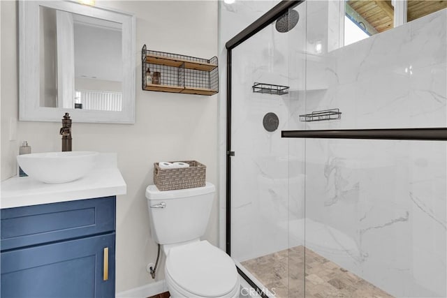 full bathroom featuring vanity, a marble finish shower, toilet, and baseboards