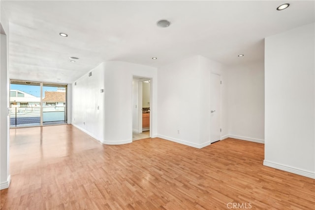 spare room featuring light hardwood / wood-style floors