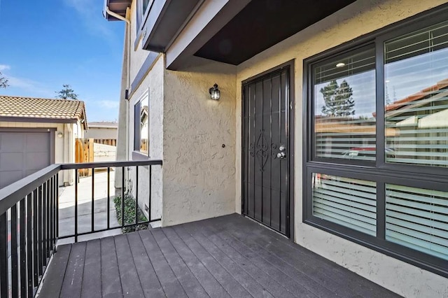 view of exterior entry featuring a balcony