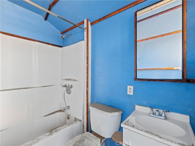 full bathroom featuring toilet, vanity, vaulted ceiling, and  shower combination