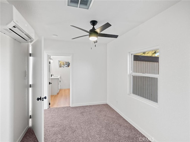 empty room featuring ceiling fan, carpet, and a wall mounted air conditioner