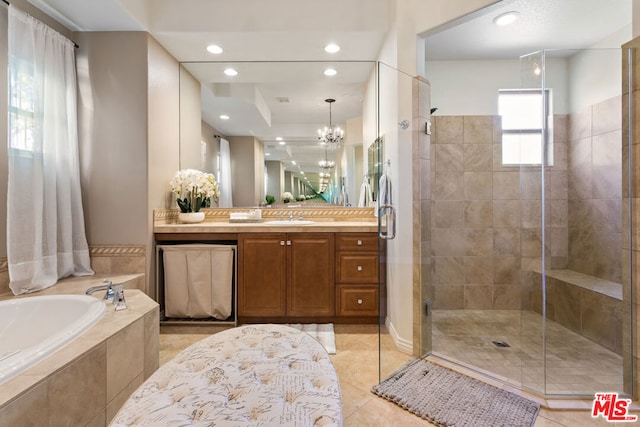 bathroom featuring a chandelier, tile patterned floors, separate shower and tub, and vanity