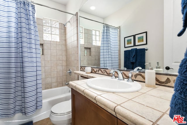 full bathroom with toilet, shower / bath combination with curtain, and vanity