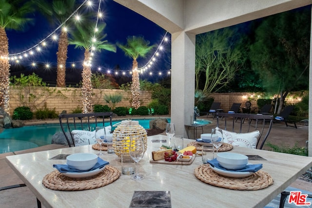 view of patio with a fenced in pool