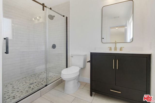 bathroom with an enclosed shower, vanity, tile patterned floors, and toilet