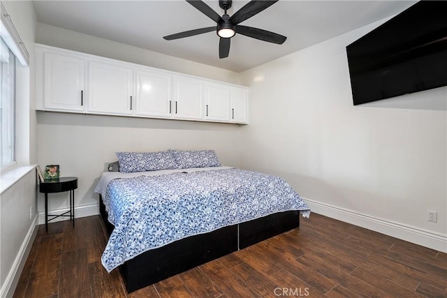 bedroom with ceiling fan and dark hardwood / wood-style floors