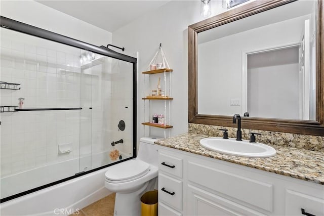 full bathroom with enclosed tub / shower combo, vanity, toilet, and tile patterned flooring