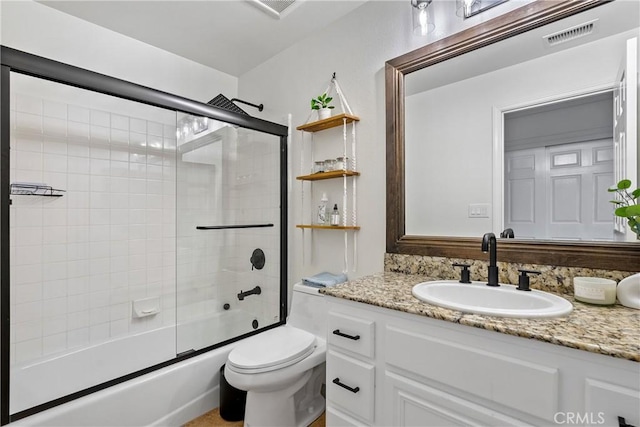 full bathroom with vanity, toilet, and combined bath / shower with glass door