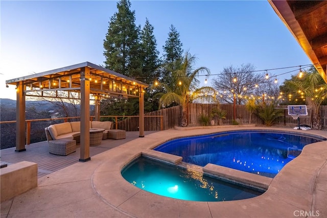 pool at dusk featuring outdoor lounge area and a patio