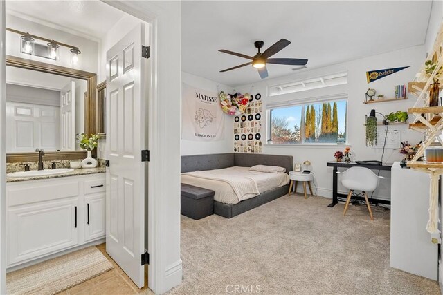 bedroom featuring sink, ceiling fan, and light carpet